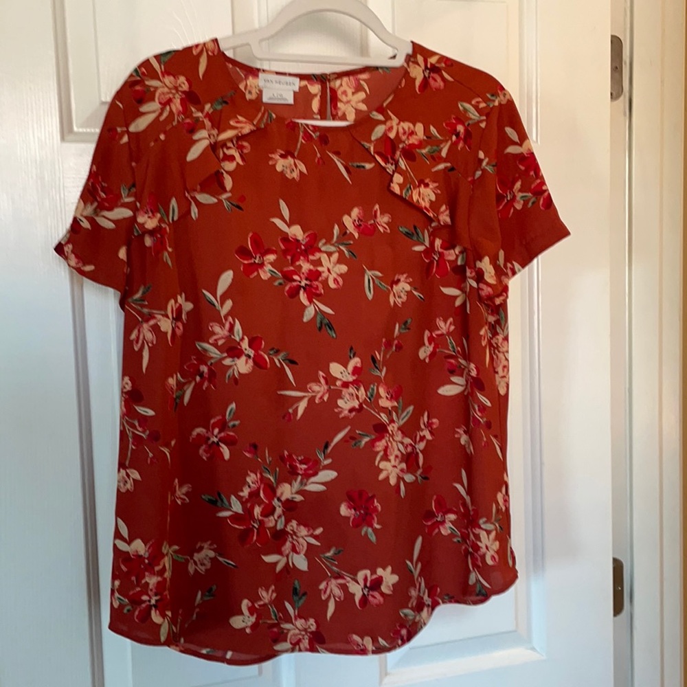 Short sleeve blouse with ruffle detail. Flattering on mid-section.